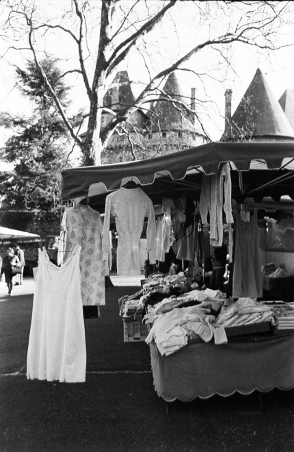 France market dresses, Market day at Pompadour, the LImousin, France, Castle of Pompadour in background. Pompadour is the site of one of 24 national stud farms of France. Extensive image collection available.