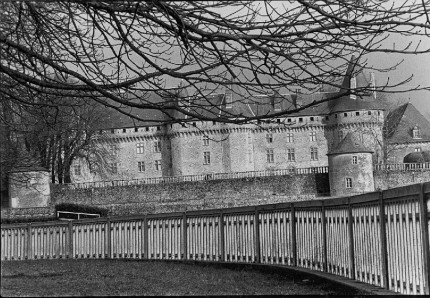 France Castle and Fence, Looking up to the castle of Pompadour from the racetrack, Races are run below the Chateau de Pompadour in the Limousin, France, home of one of 24 national stud farms.