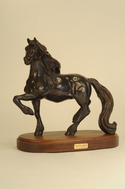 “Horse Power” This Friesian horse from Holland is known as the “Feathered” horse and recognized for its long mane and tail that stretches to the ground. (L.E. 35) 25”L x 8” W x 15”H - Wood Swivel Base