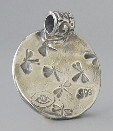 “Ahead By A Nose” 1" diameter, Price: $189, Chisholm Ref. #: S-SH2 - This silver piece captures the excitement of a close horse race. Horses and jockeys vie for position in the foreground. Behind them spectators crowd the rail with the grandstand rising in the background. Handcrafted in .960 silver.