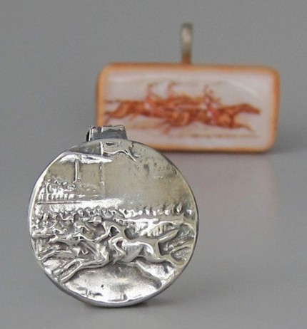 “Ahead By A Nose” 1" diameter, Price: $189, Chisholm Ref. #: S-SH2 - This silver piece captures the excitement of a close horse race. Horses and jockeys vie for position in the foreground. Behind them spectators crowd the rail with the grandstand rising in the background. Handcrafted in .960 silver.