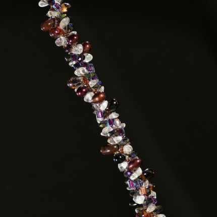 “Cabernet Horseshoe Beaded Necklace” Overall length: 19.25", Pendant diameter: 7/8", Price: $550, Chisholm Ref. #: SBW-N2 | One-of-a-kind silver & beadwork necklace is woven with clear quartz crystal beads, Czech fire polished crystals, a colorful blend of square Japanese glass beads, and teardrop shaped glass beads in a rich wine color. The end-caps are textured with warm blood breed logos, and the focal piece is a horseshoe as seen from the farrier's point of view. The findings are all handcrafted in .960 silver.