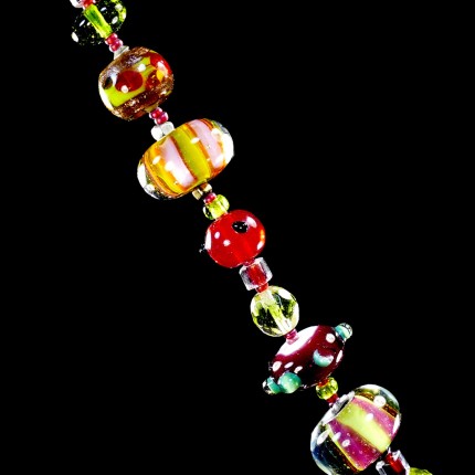 “Glowing Glass Bracelet” Overall length: 8.5", Price: $229, Chisholm Ref. #: SB-111 | One of a kind bracelet made with brilliant, lamp-worked, glass beads, vintage crystal, and glass seed beads. The round toggle clasp bears the logos of the major warmblood breeds. Findings handcrafted in .960 silver.