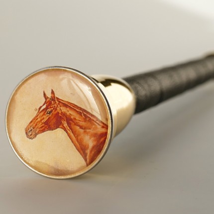 “Handsome Chestnut Dressage Whip” Regulation length: 120cm, Price: $135, Chisholm Ref. #: EWW3 - This is the Handsome Chestnut Dressage Whip, made in collaboration with the venerable Westfield Whip Manufacturing Co. It is leather wrapped with a brass ferrule and a weighted brass cap. It is finely balanced and fairly stiff. The embellishment is a paper image under an epoxy resin cap.
