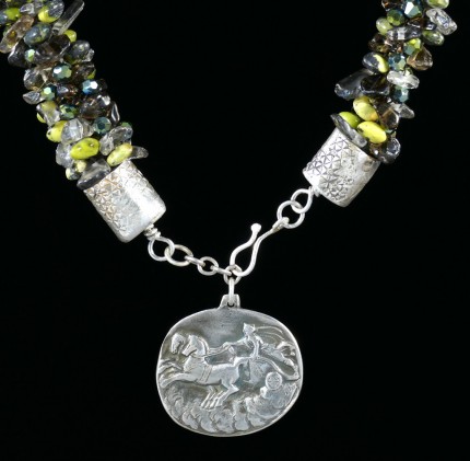 “Jade Chariot Beadwork & Silver Necklace” Pendant: 1.25" x 1.125", Overall length: 22", Price: $650, Chisholm Ref. #: SBW-N5 - This one-of-a-kind silver and beadwork necklace is made of yellow jade, smokey quartz, and Czech fire-polished crystals. The handmade end caps are lightly textured, and the focal pendant is a stunning classical charriot made in .960 silver.