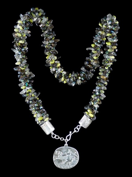“Jade Chariot Beadwork & Silver Necklace” Pendant: 1.25" x 1.125", Overall length: 22", Price: $650, Chisholm Ref. #: SBW-N5 - This one-of-a-kind silver and beadwork necklace is made of yellow jade, smokey quartz, and Czech fire-polished crystals. The handmade end caps are lightly textured, and the focal pendant is a stunning classical charriot made in .960 silver.