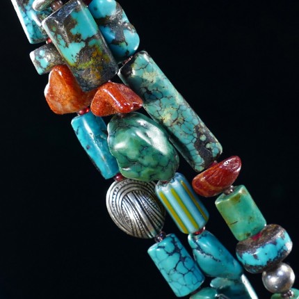“Ocean Inspiration Bracelet” Overall length: 8", Price: $329, Chisholm Ref. #: SB-111 | One of a kind beaded bracelet made with three strands of turquoise, red coral, silver, and antique trade beads. The end caps are sterling silver, machine handmade. The large handmade clasp shows a mesmerizing wave pattern which is perfectly paired with a seashell shaped closure. Clasp handcrafted in .960 silver.