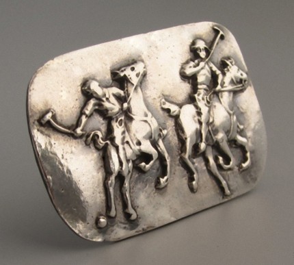 “Polo Action” Price: $289, Chisholm Ref #: S-SH1 - Two polo player jostle for position as one prepares to strike the ball. Handcrafted in .960 silver. Strong on black leather cord with sterling clasp.