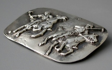 “Polo Action” Price: $289, Chisholm Ref #: S-SH1 - Two polo player jostle for position as one prepares to strike the ball. Handcrafted in .960 silver. Strong on black leather cord with sterling clasp.