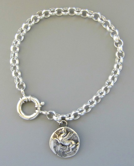 “Polo Charge” 7/8" Diameter, Price: $179, Chisholm Ref. #: S-SH4 | Here a polo player and pony act as one in pursuit of the ball. This piece captures the magic that happens when the border between horse and rider seems to disappear. Hand crafted in .960 silver.