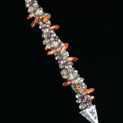 “Triple Luck Beaded Necklace” Overall length: 19", Pendant: 1.25" x 1.25", Price: $550, Chisholm Ref. #: SBW-N11 | One-of-a-kind silver & beadwork necklace made of freshwater pearls, Czech fire polished crystals, Czech glass dagger beads, and glass seed beads. The handmade, silver end-caps are textured with a motif of warmblood breed logos. The focal piece of the necklace is a convex, triangular pendant with the dramatic silhouette of a running horse. The findings are all handcrafted in .960 silver.